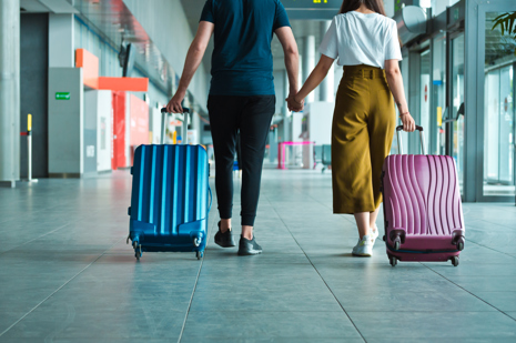 Back view of passengers at the airport with luggage.jpg