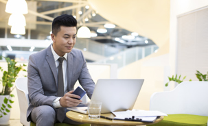 Businessman using laptop in office.jpg