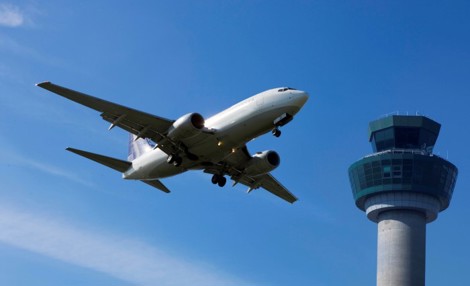 Aircraft in sky passing atm tower