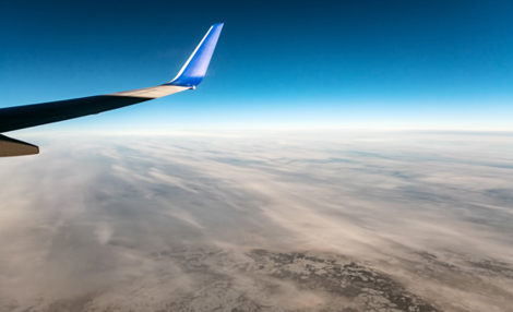 Aicraft wing tip over cloudy landscape