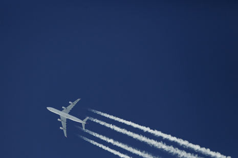 Aircraft, contrails and blue sky